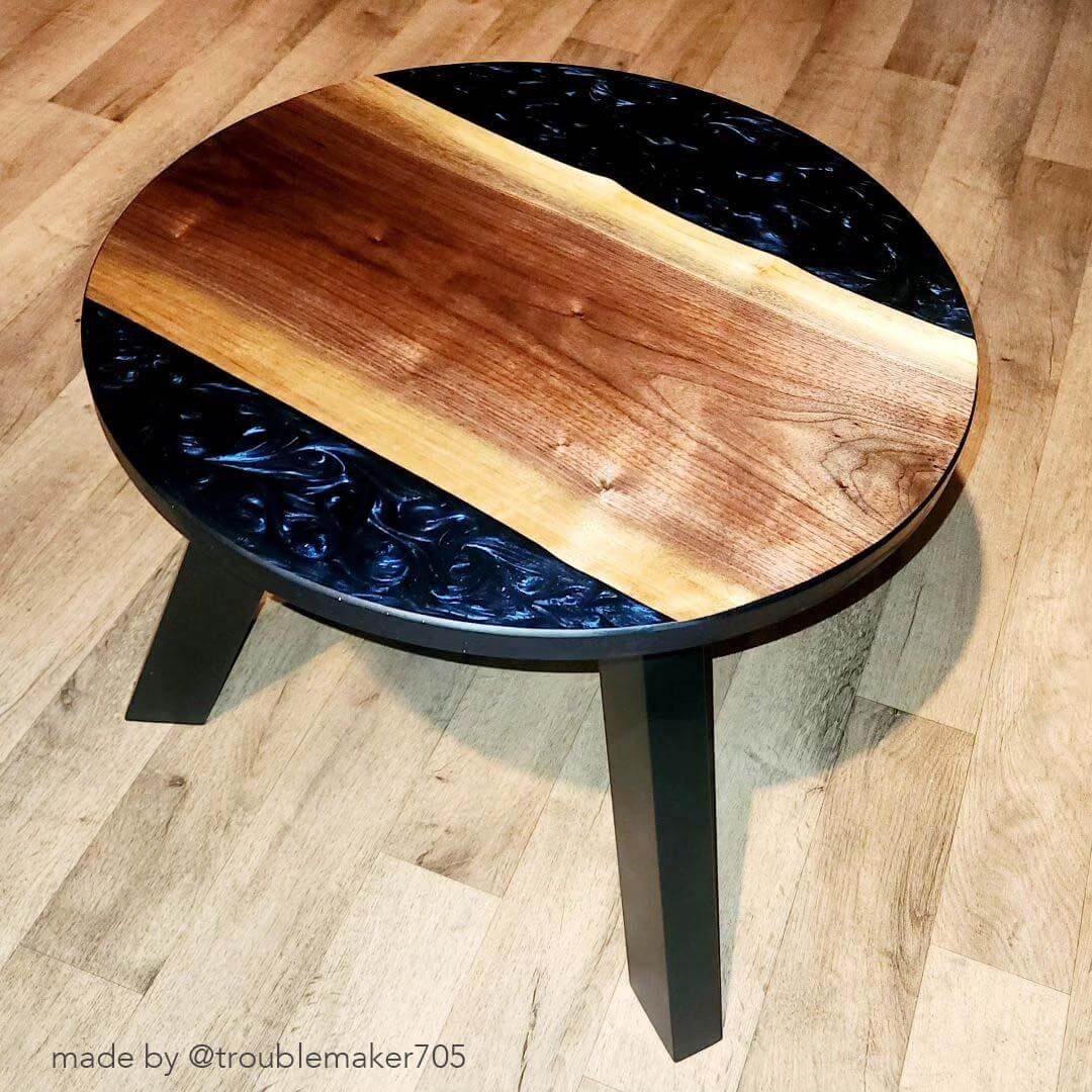 Coffee table with angled black legs and oval tabletop