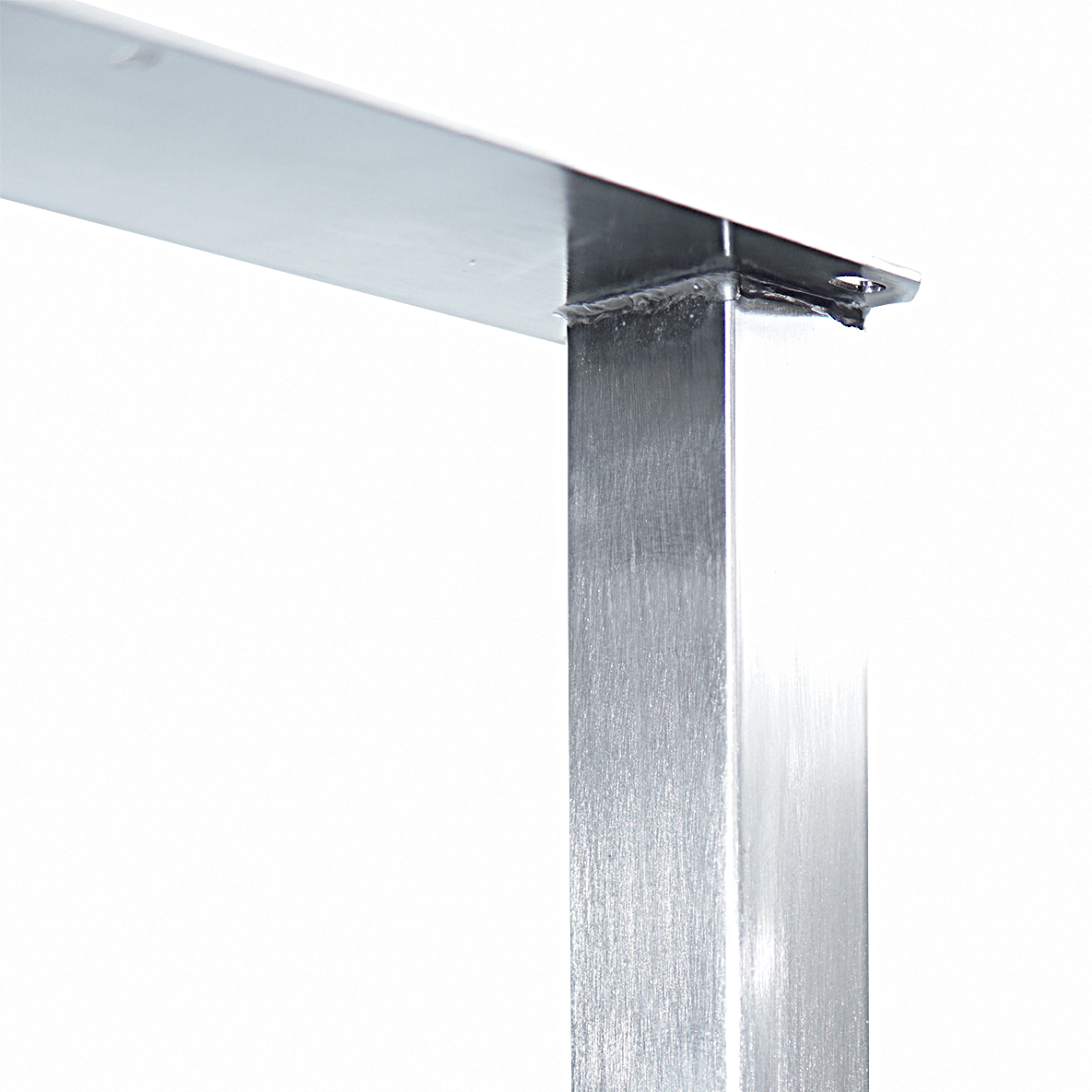 Silver U-shaped table leg joint with welded corner under top