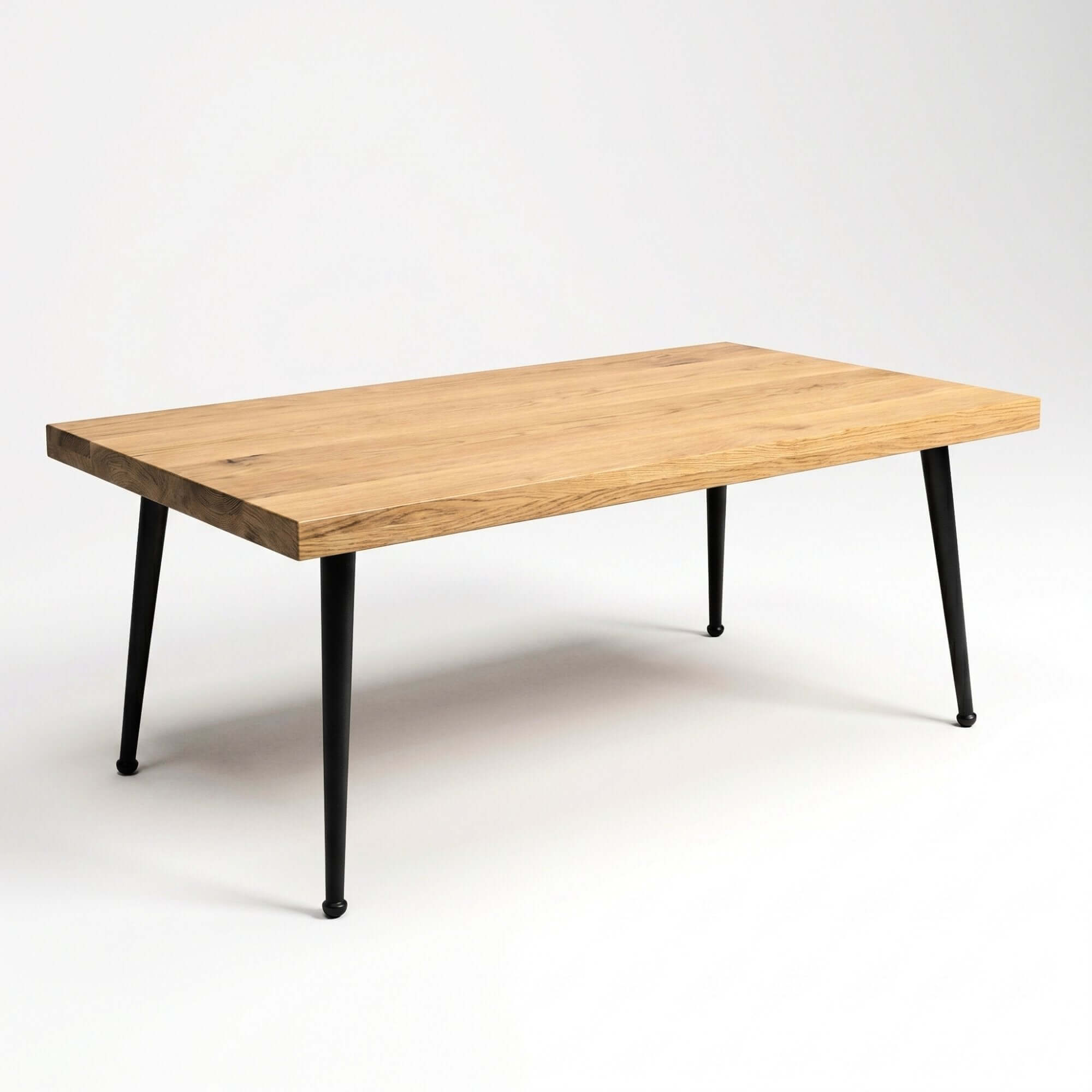 Black cone coffee table legs supporting a light wood tabletop