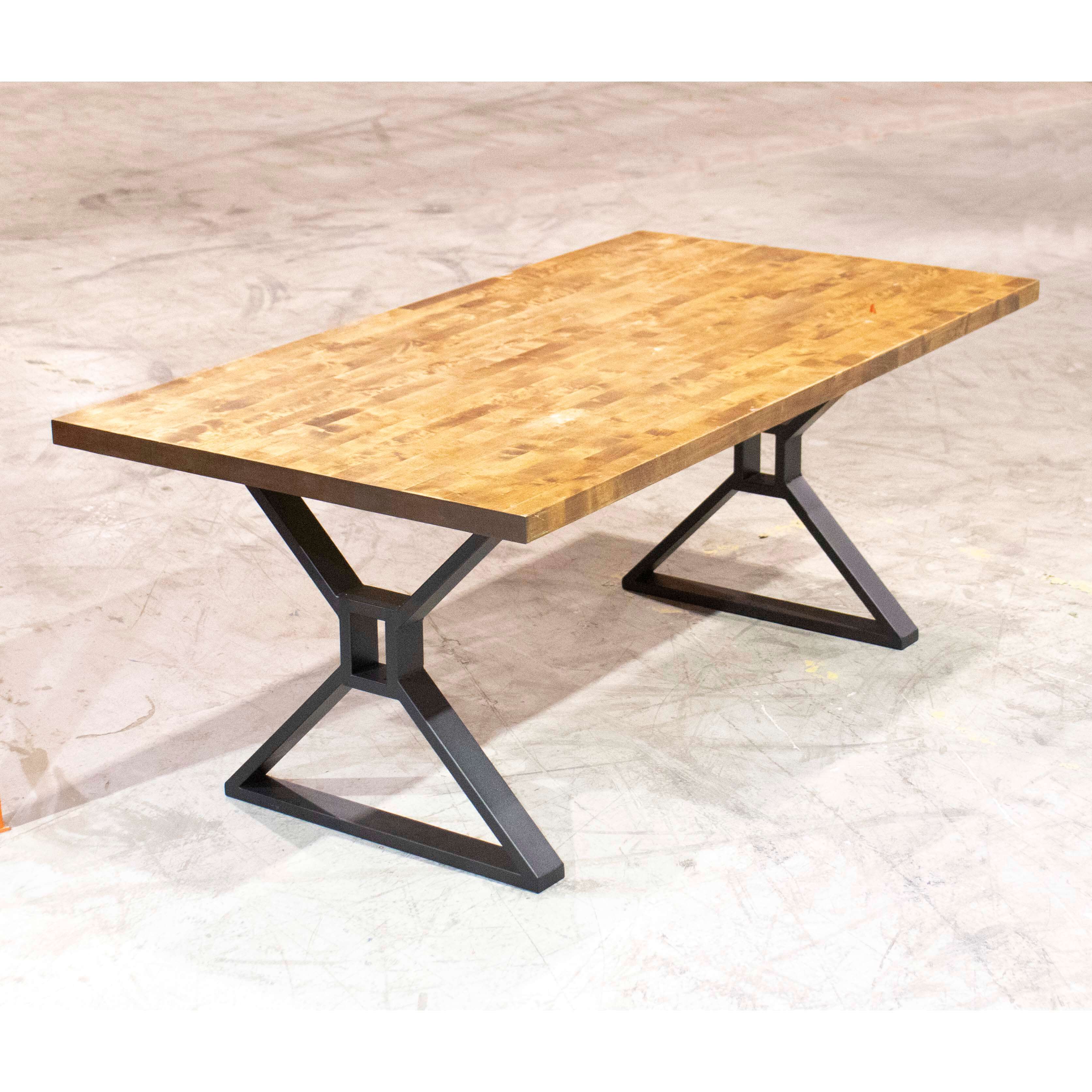 Dining table legs with X-shaped metal frames, dark supports under a wood top