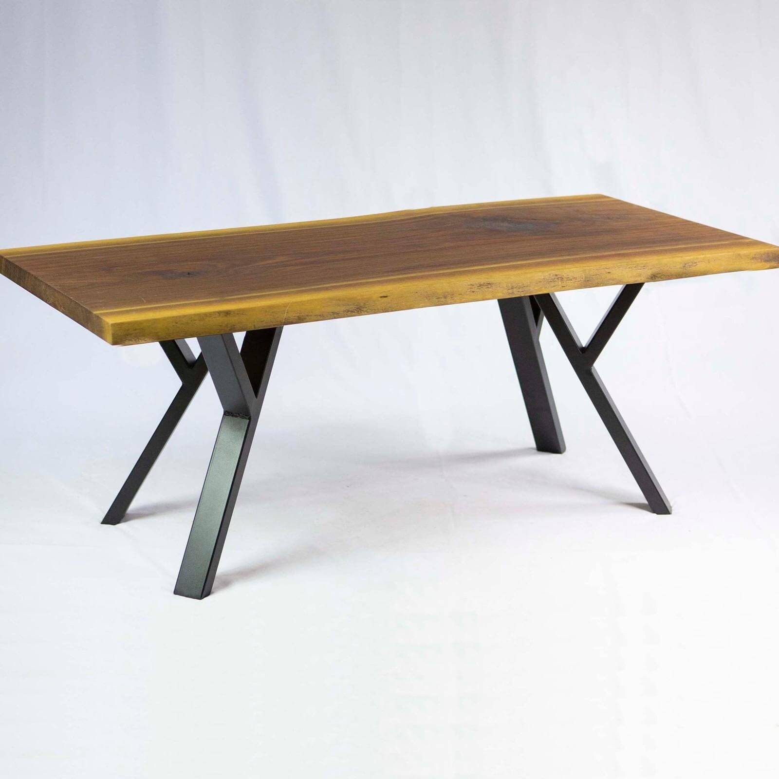 Y-shaped coffee table legs in black powder coat, supporting a wooden tabletop