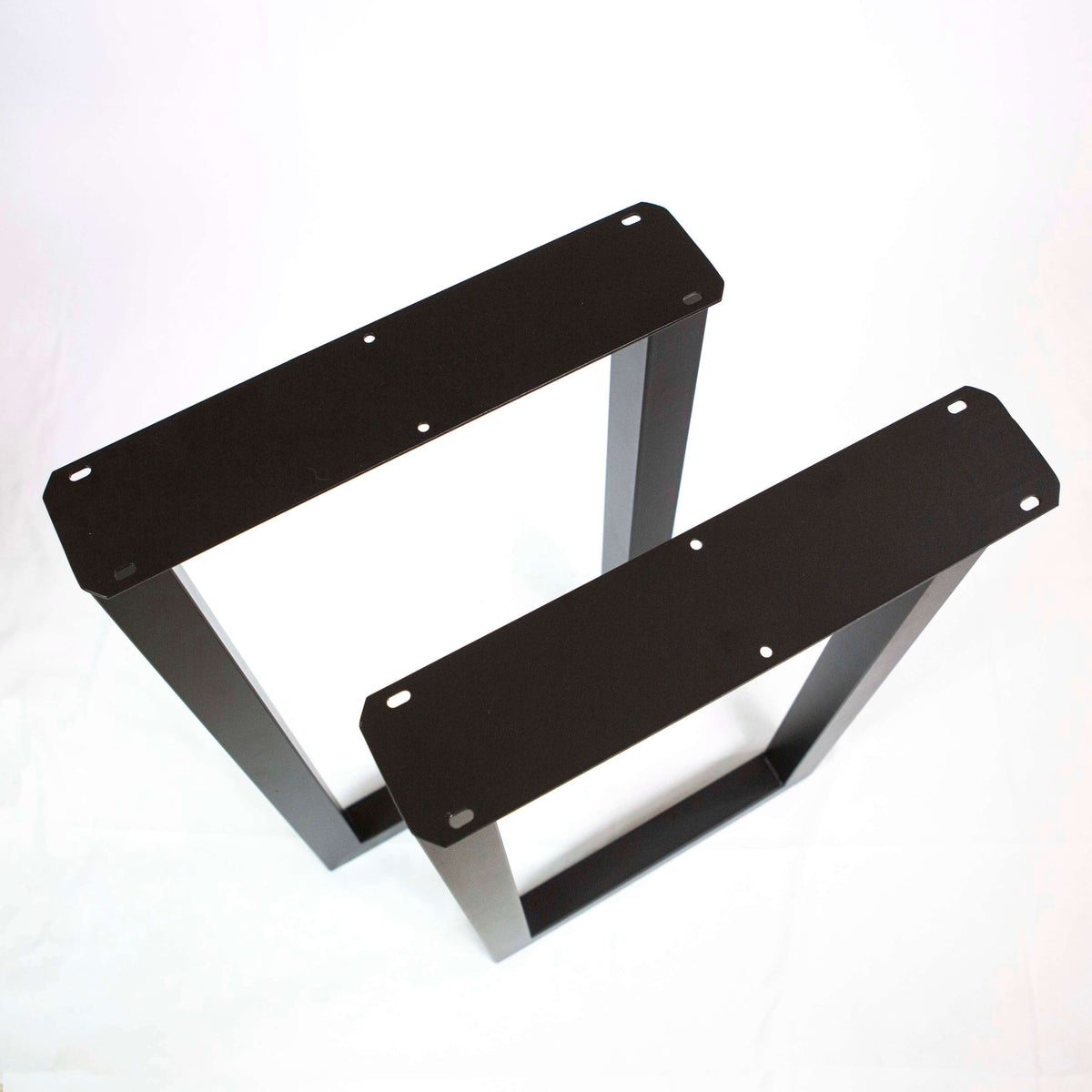 Pair of black U-shaped metal table legs with mounting holes