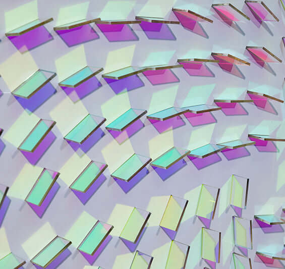 Close-up of holographic prismatic bars forming a swirling spiral with white glow