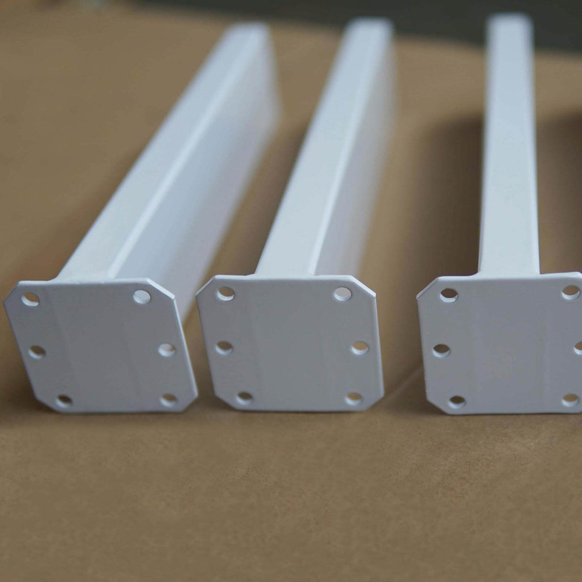 Angled coffee table legs mounting plates, light gray steel with bolt holes