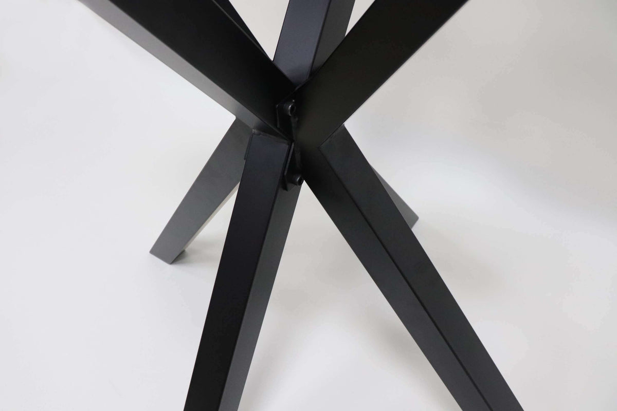 Spider dining table base close-up of black leg junction and cross braces