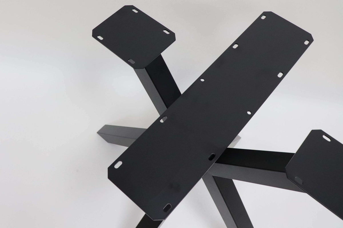 Spider dining table base with black cross braces and round connection bolts