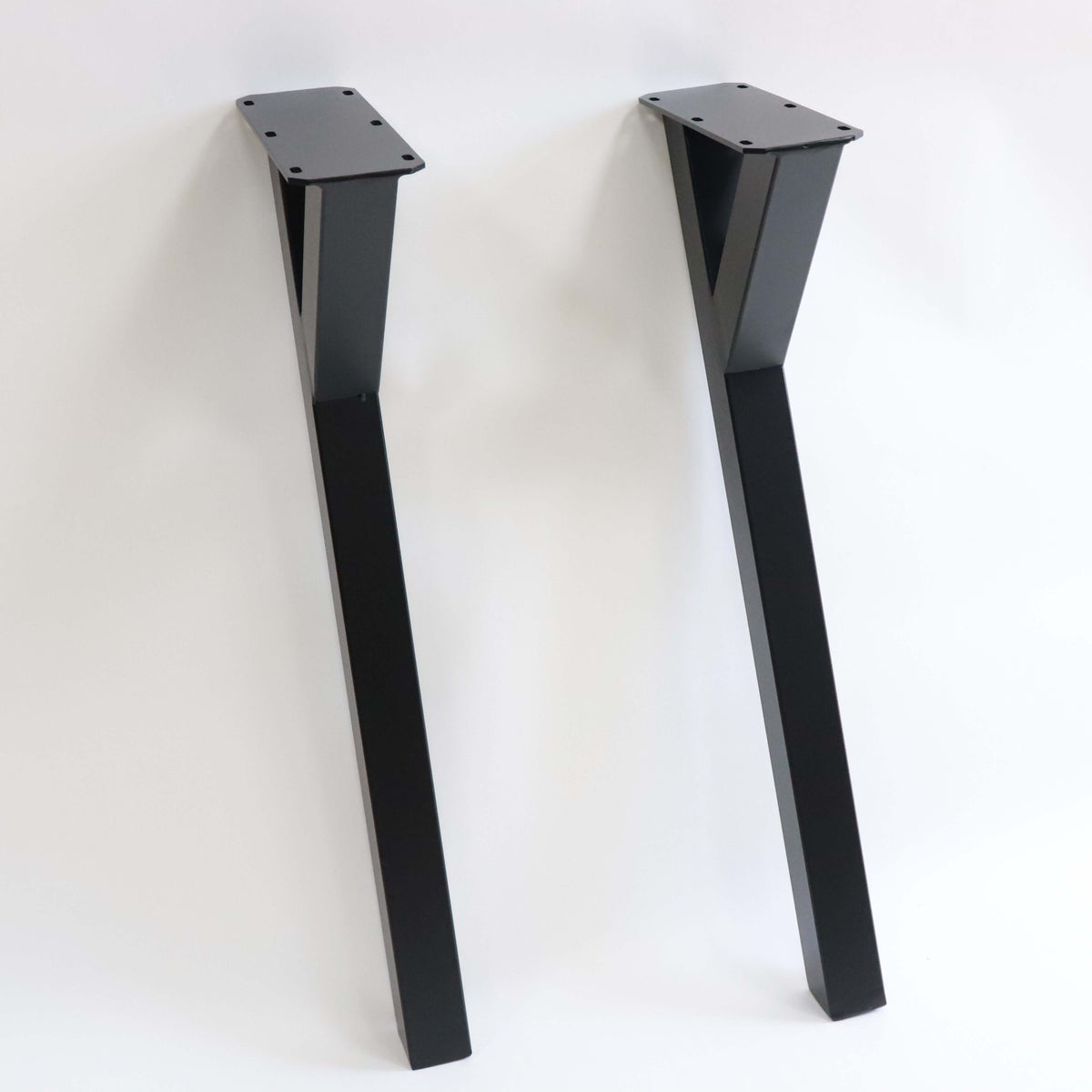 Black powder-coated Y-shaped dining table legs, two legs shown