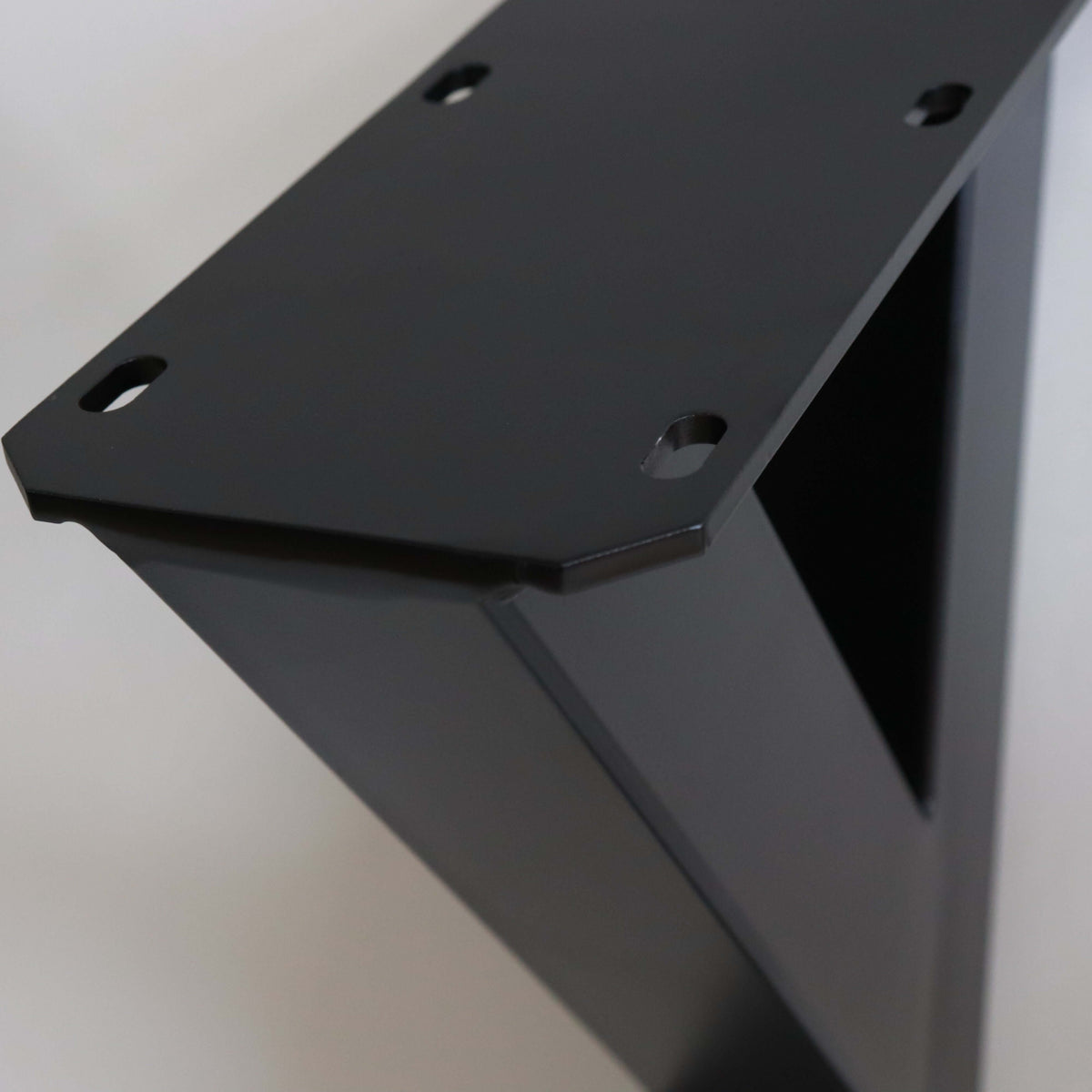 Black Y-shaped dining table leg top plate with bolt holes and corner bracket