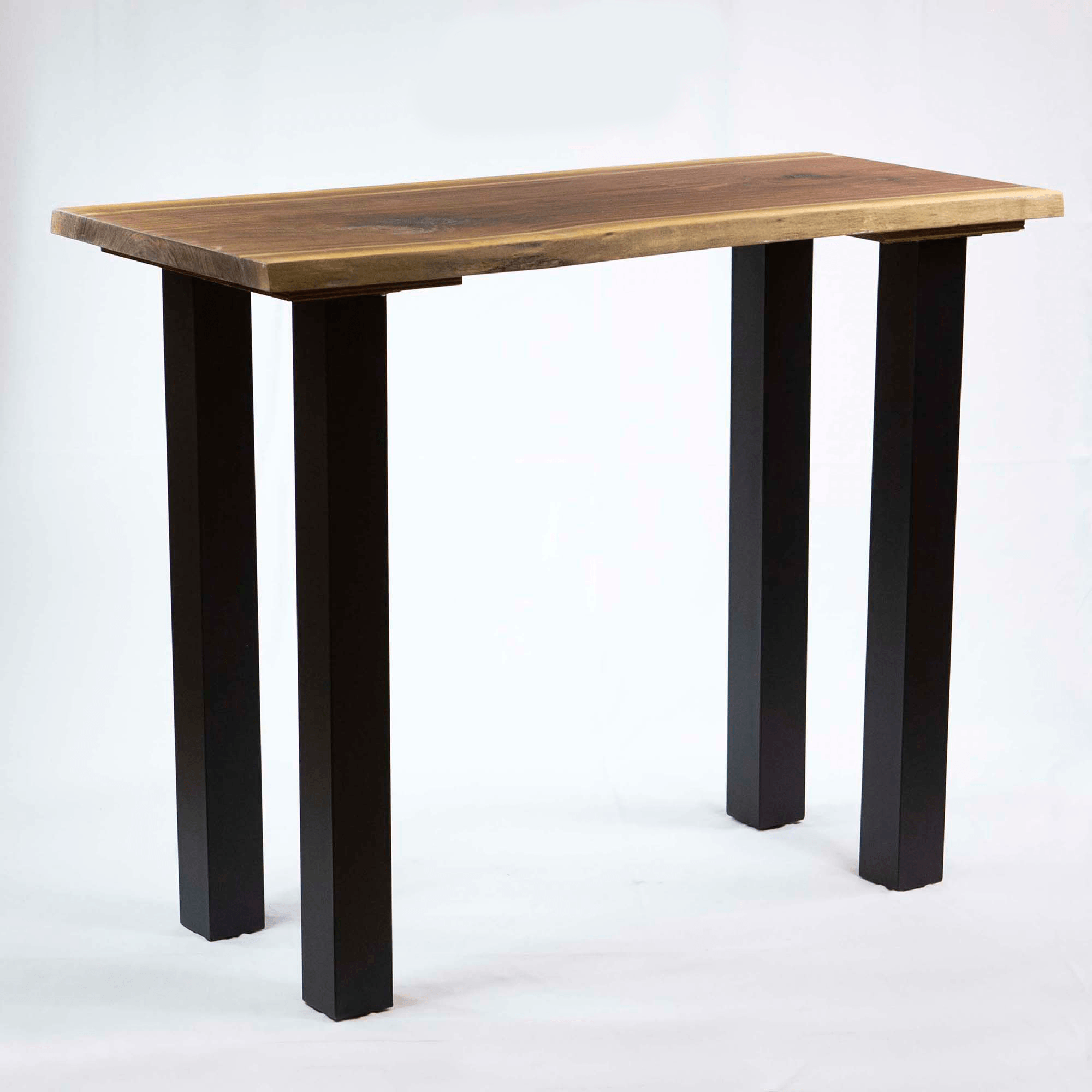 Set of four black powder-coated table legs with square column profile under a tabletop