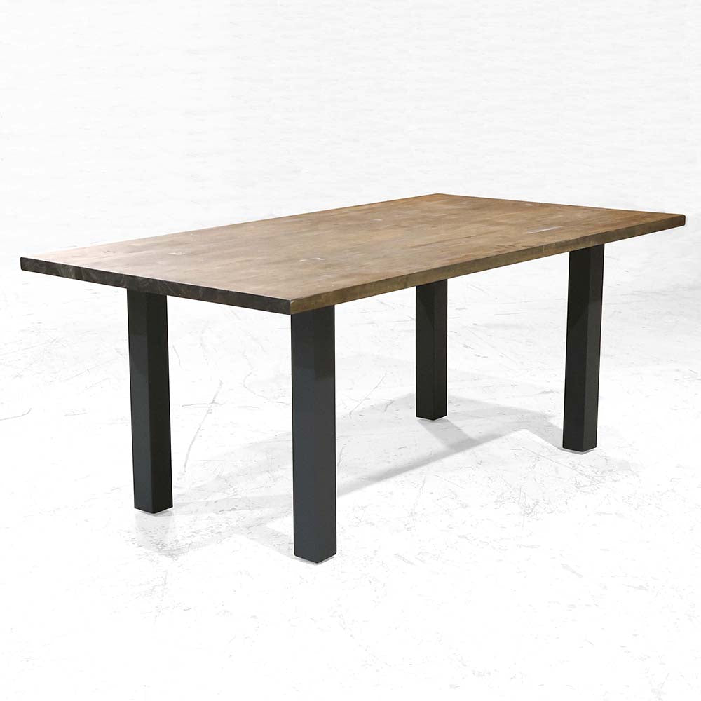 Modern dining table with wood top supported by four SS1010 column-style legs in a blank setting.