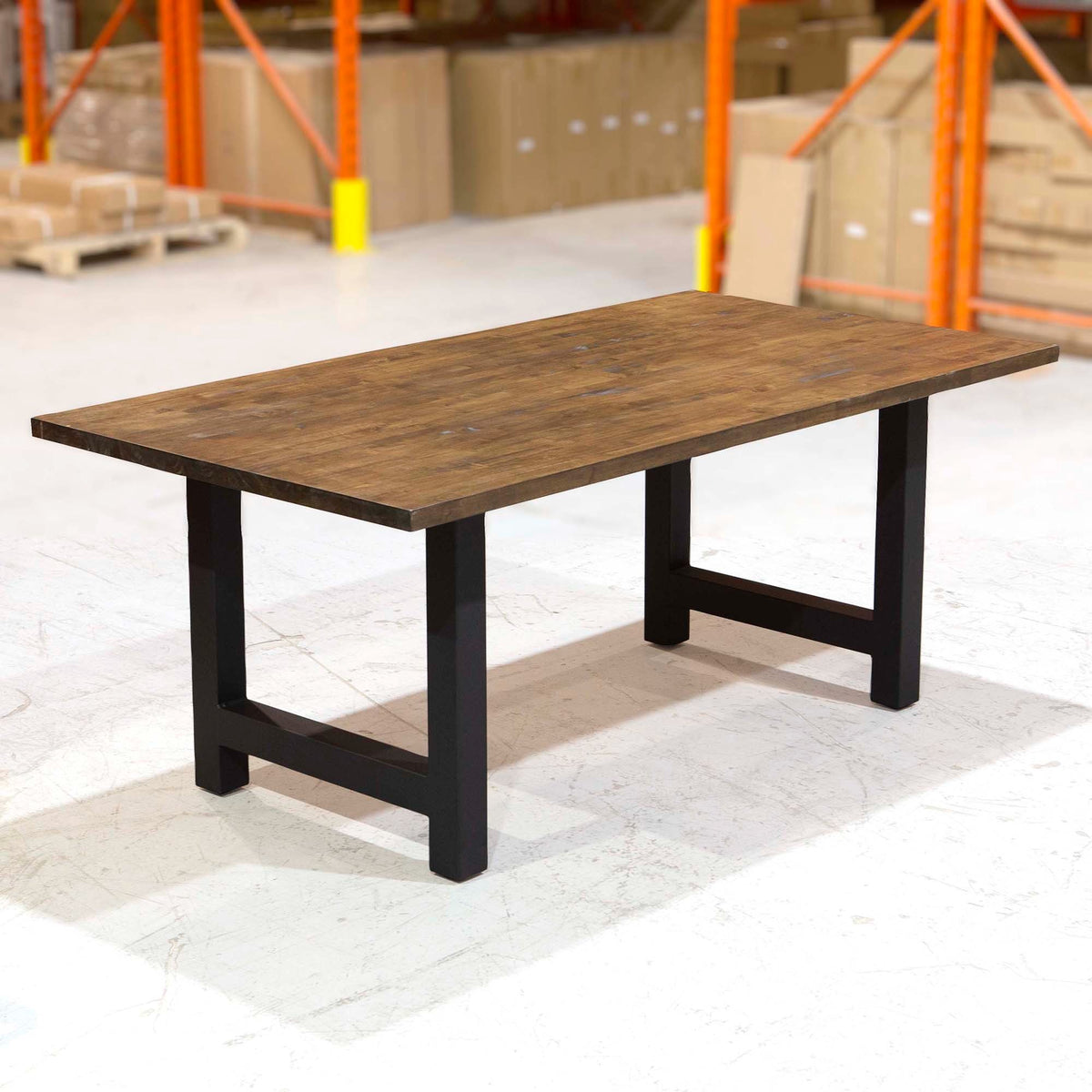 Wood-top dining table with black H-legs and rectangular support frame